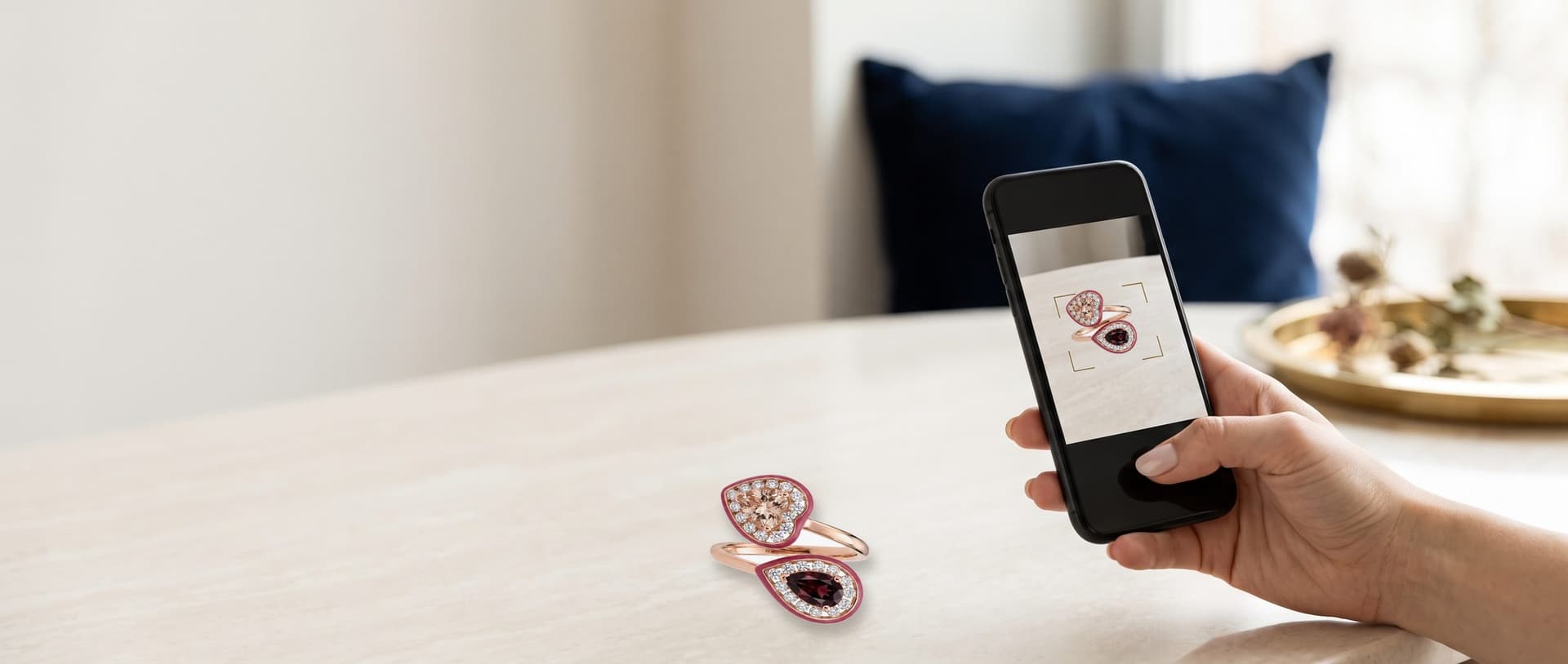A phone camera pointed at a rose gold ring, showing it on the screen